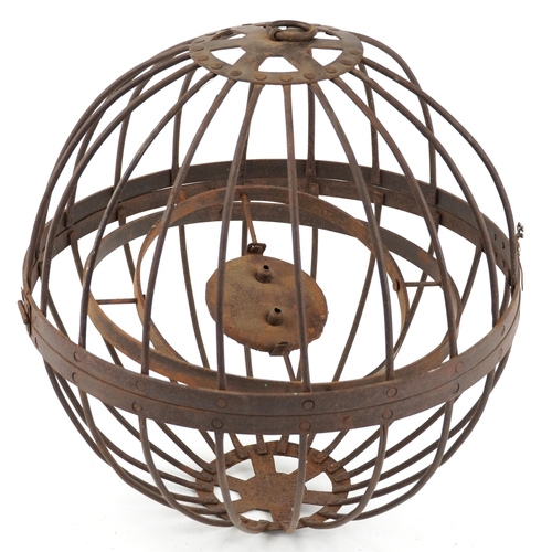 555 - An antique wrought iron hanging candle gimbal cage, approximately 46cm in diameter