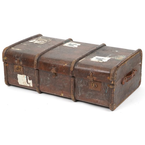 2033 - An early 20th century faux leather canvas bound travelling trunk, 93cm wide.