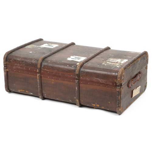 2033 - An early 20th century faux leather canvas bound travelling trunk, 93cm wide.