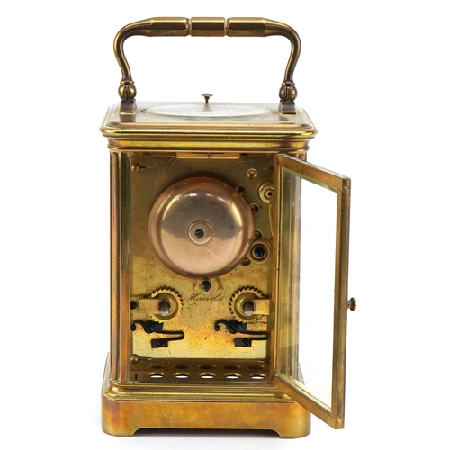 203 - A 20th century gilt brass repeater carriage clock with swing handle, the white enamel dial with blac... 