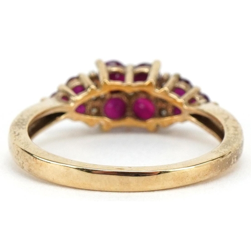 3086 - A 9ct gold ruby and diamond cluster dress ring, size O, 2.6g.