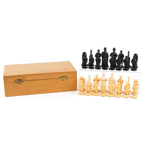 1147 - A 20th century resin chess set, the king 10cm high, within a wooden box, 35cm wide.