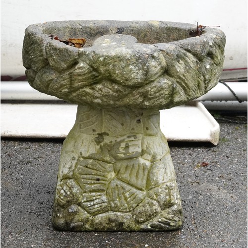 2177 - A 20th century concrete birdbath raised on a naturalistic base, 31cm high.