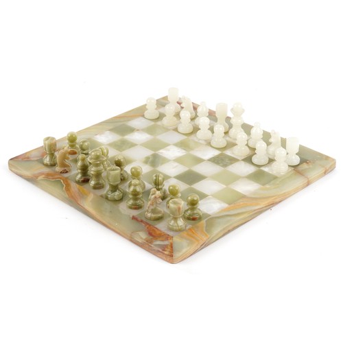 1148 - A carved green onyx chess set with board, the board 40cm x 40cm.