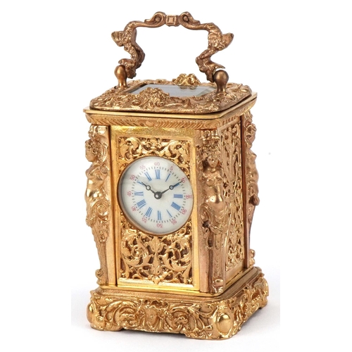 2543 - A miniature gilt brass Rococo style carriage clock, the enamelled dial with Roman numerals and swing... 