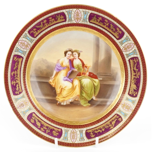 A 19th century Austrian Royal Vienna porcelain plate entitled Musik & Poesie, hand painted by W. Lang, with gilt decoration, marks to base, 24cm in diameter.