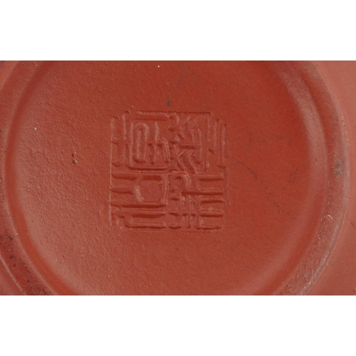 143 - A Chinese Yixing stoneware teapot, 20th century, bearing four character mark to base, 10cm high, tog... 