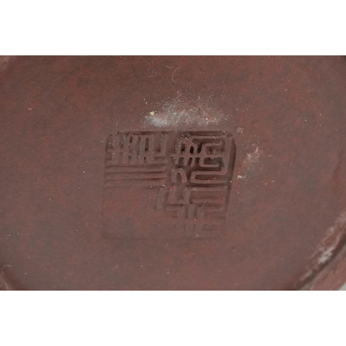 143 - A Chinese Yixing stoneware teapot, 20th century, bearing four character mark to base, 10cm high, tog... 
