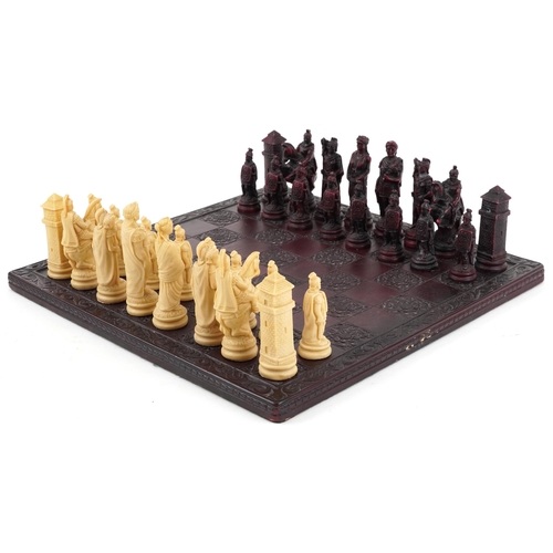 1041 - A late 20th century wax chess set, the king 11cm high, together with a stained and carved hardwood b... 