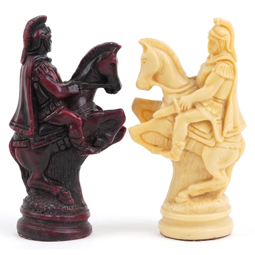 1041 - A late 20th century wax chess set, the king 11cm high, together with a stained and carved hardwood b... 