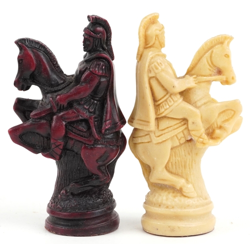 1041 - A late 20th century wax chess set, the king 11cm high, together with a stained and carved hardwood b... 