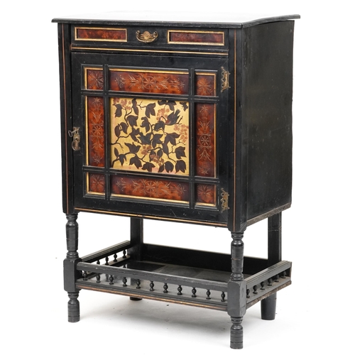 A late 19th century Aesthetic Movement ebonised and burr walnut side cabinet, circa 1880, fitted with a drawer above a cupboard with gilt and painted floral decoration above a galleried under tier raised on ring turned supports, 100cm H x 68cm W x 43cm D.