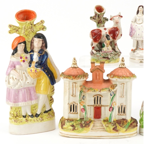 216 - Collection of Victorian and later Staffordshire pottery figure groups and spill vases, the largest 2... 