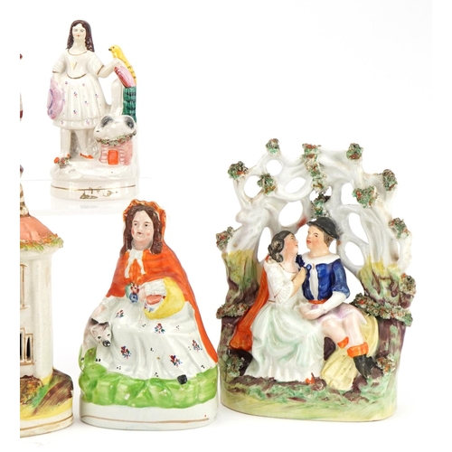 216 - Collection of Victorian and later Staffordshire pottery figure groups and spill vases, the largest 2... 