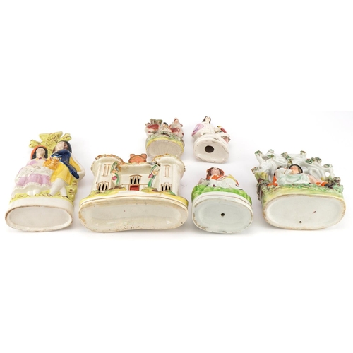 216 - Collection of Victorian and later Staffordshire pottery figure groups and spill vases, the largest 2... 