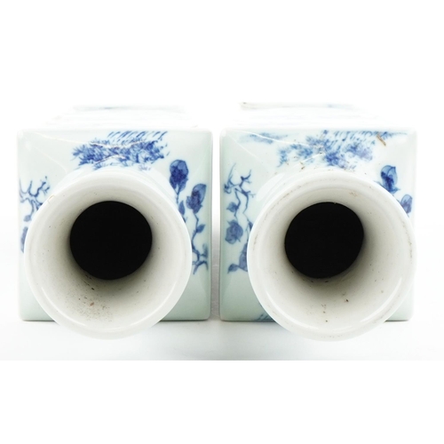 165 - A pair of Chinese porcelain blue and white flat sided vases hand painted with figures amongst mounta... 