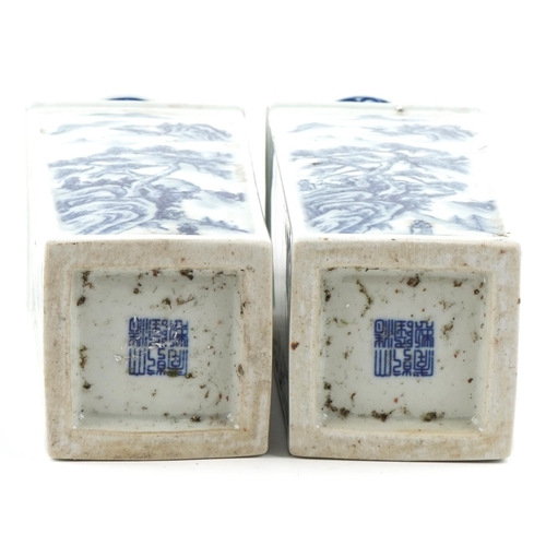 165 - A pair of Chinese porcelain blue and white flat sided vases hand painted with figures amongst mounta... 