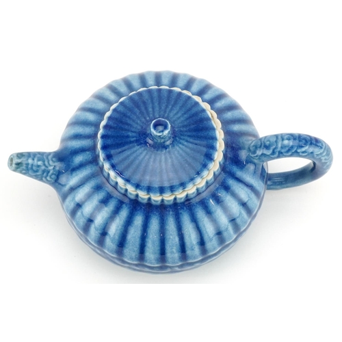 139 - A Chinese porcelain blue glazed teapot, character marks to the base, 18cm in length.