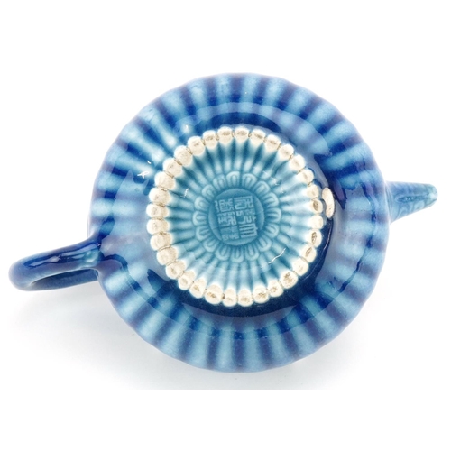 139 - A Chinese porcelain blue glazed teapot, character marks to the base, 18cm in length.