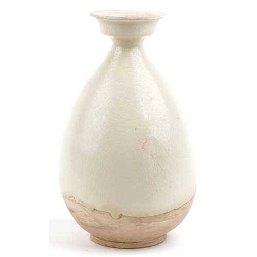 225 - A Chinese cream glazed pottery vase, 26cm high.