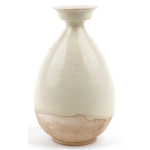 225 - A Chinese cream glazed pottery vase, 26cm high.