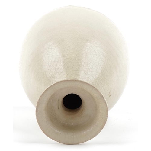 225 - A Chinese cream glazed pottery vase, 26cm high.