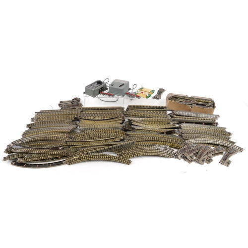1052 - A large collection of vintage Hornby OO gauge tinplate model railway track, switches and two control... 