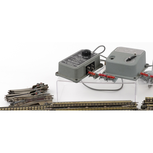 1052 - A large collection of vintage Hornby OO gauge tinplate model railway track, switches and two control... 