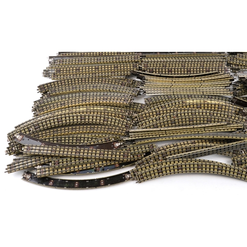 1052 - A large collection of vintage Hornby OO gauge tinplate model railway track, switches and two control... 
