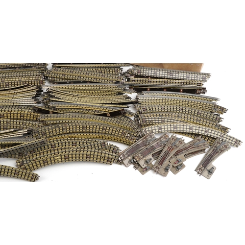 1052 - A large collection of vintage Hornby OO gauge tinplate model railway track, switches and two control... 
