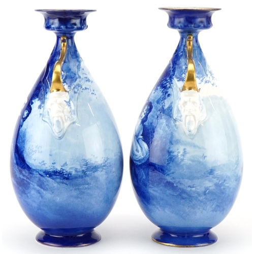 99 - A pair of Royal Doulton Blue Children series ware vases with twin grotesque mask handles, 29.5cm hig... 
