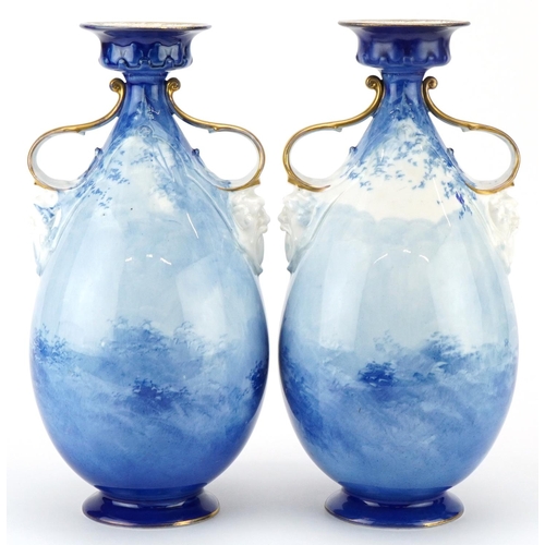 99 - A pair of Royal Doulton Blue Children series ware vases with twin grotesque mask handles, 29.5cm hig... 