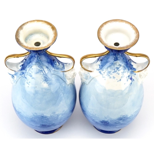 99 - A pair of Royal Doulton Blue Children series ware vases with twin grotesque mask handles, 29.5cm hig... 