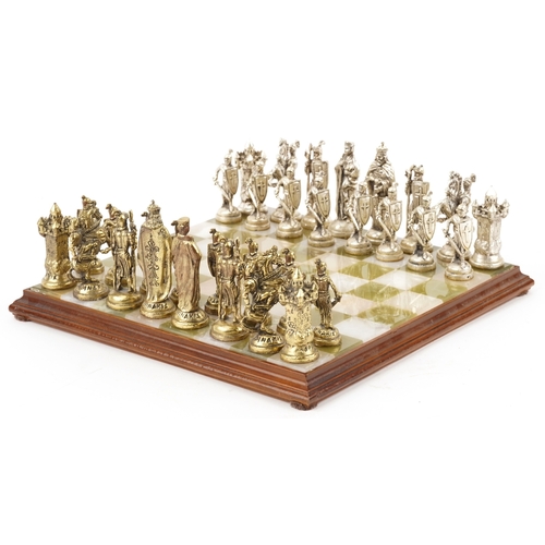 1038 - A Forma cast metal chess set, the king 8.5cm high, together with an onyx and alabaster chequer board... 