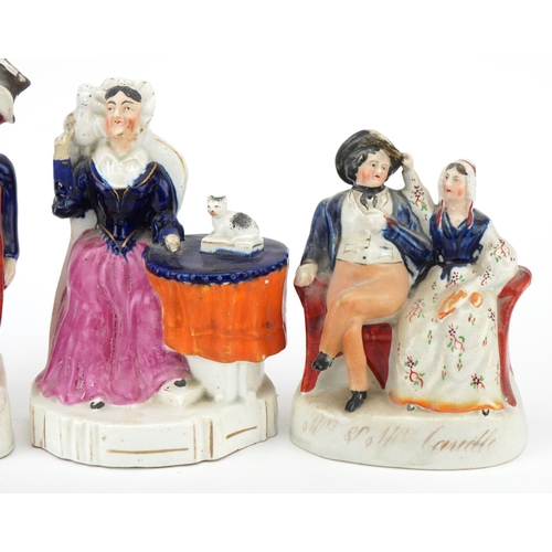 201 - Two Victorian Staffordshire pottery figure groups of Mr. & Mrs. Candle together with a seated female... 