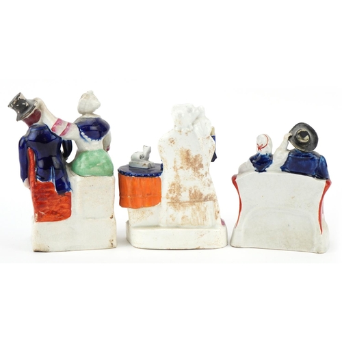 201 - Two Victorian Staffordshire pottery figure groups of Mr. & Mrs. Candle together with a seated female... 