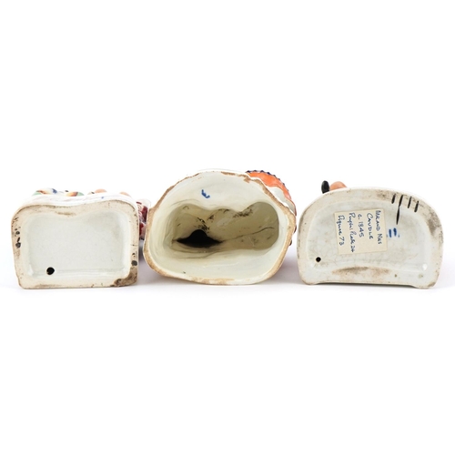 201 - Two Victorian Staffordshire pottery figure groups of Mr. & Mrs. Candle together with a seated female... 