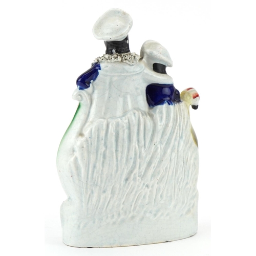 175 - A Victorian Staffordshire pottery flatback of a couple on a boat, 23cm high.