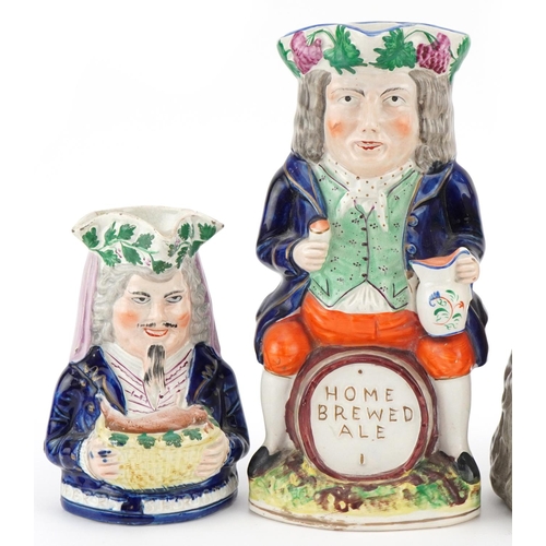 215 - A Victorian Staffordshire pottery Toby Jug 'Merry Christmas' , a Greek Bacchus Toby jug and a Home B... 