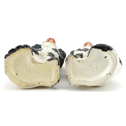 218 - A pair of Staffordshire pottery black and white Spaniels, 14cm high.