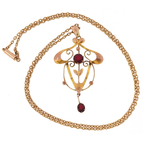 3045 - An Art Nouveau 9ct gold amethyst coloured glass openwork pendant on a 9ct gold necklace, 4.4cm high ... 