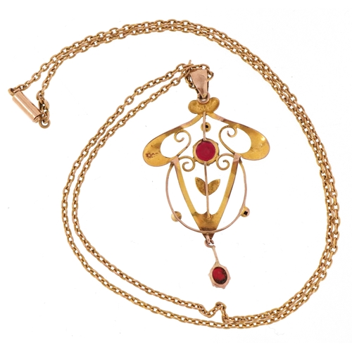3045 - An Art Nouveau 9ct gold amethyst coloured glass openwork pendant on a 9ct gold necklace, 4.4cm high ... 