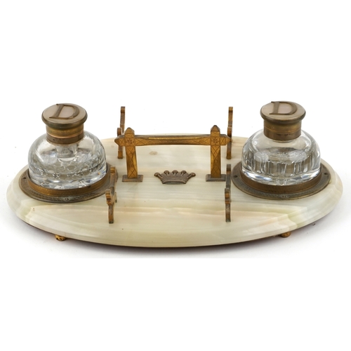 10 - An early 20th century onyx and gilt metal mounted desk stand fitted with two cut glass inkwells, eac... 