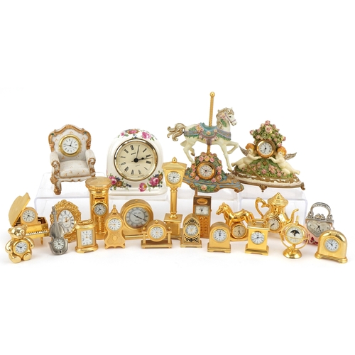 A collection of miniature brass and resin decorative clocks in various ...