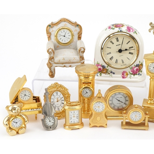 A collection of miniature brass and resin decorative clocks in various ...