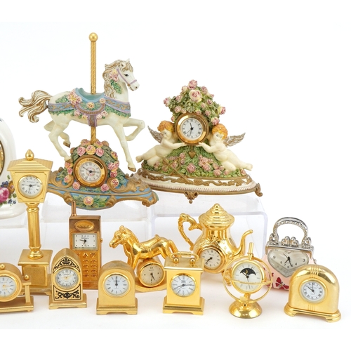 A collection of miniature brass and resin decorative clocks in various ...