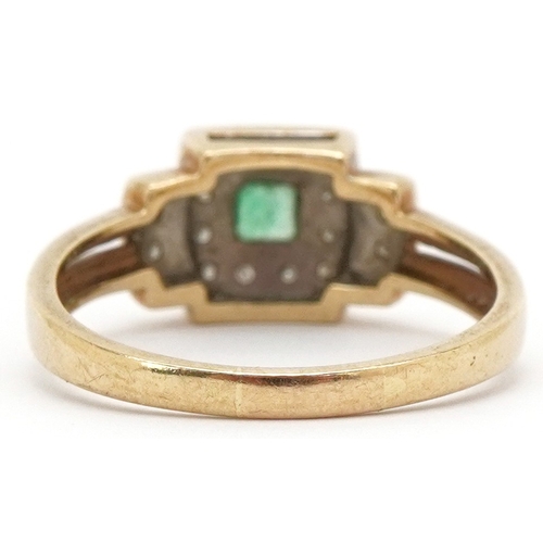 3033 - An Art Deco style 9ct gold emerald ring with diamond set stepped shoulders, size R, 3.5g.