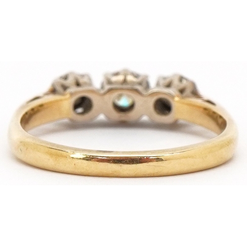 3026 - An 18ct diamond three stone ring, size L, 3.3g.