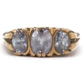 A 9ct gold graduated purple stone ring with ornate shoulders, size L, 3.6g.
