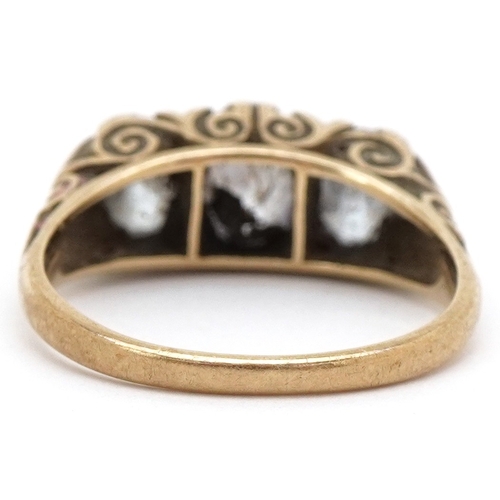 A 9ct gold graduated purple stone ring with ornate shoulders, size L, 3.6g.